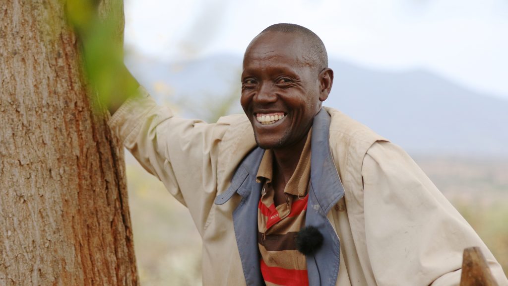 Mulandi Nzama, one of the Better Globe's partner farmers planting Mukau trees on his land.
